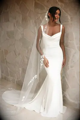Bride wearing a white crepe mermaid wedding dress 