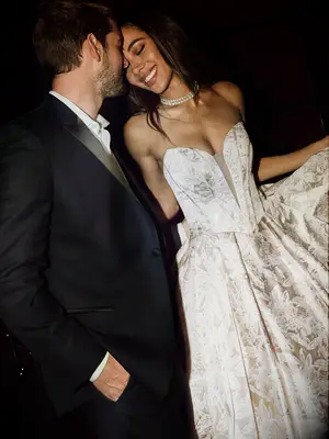 Bride wearing a structured beige wedding gown made out of damask fabric