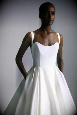 Bride wearing a white a-line wedding gown made out of faille fabric