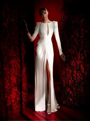 Long sleeve gown with padded shoulders, high slit and keyhole opening