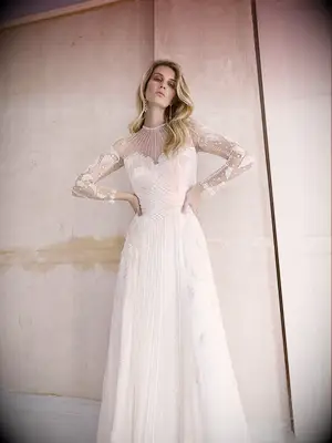 Illusion sleeves and high neckline with pearls and beading
