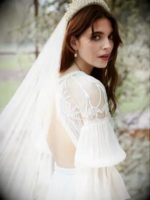 Open back and puff sleeves with pearl detailing and chiffon skirt