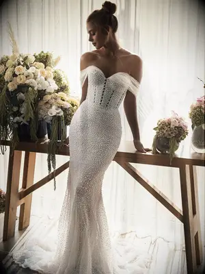 Fit and flare gown with corset top, tulle off the shoulder sleeves and pearls all over