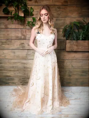 Slip dress with gold moon and star overlay and black tie straps