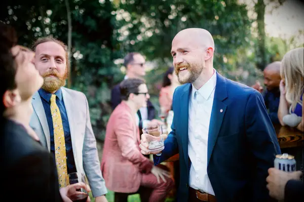 Guests wearing suits at vineyard wedding