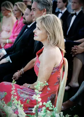 Guests at wedding wearing suits and floral dress