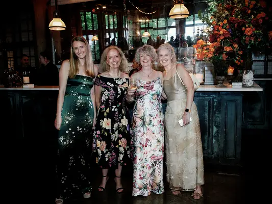 Guests wearing floral dresses at vineyard wedding