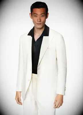Off white 70s-inspired suit by SuitSupply. 