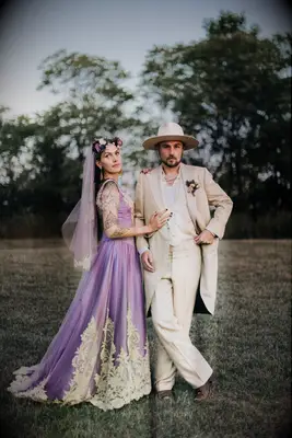 Groom wears a 70s-inspired suit. 