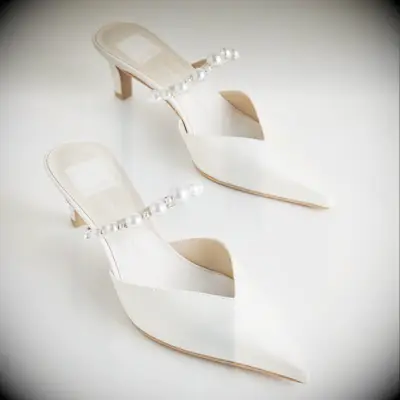 White pointed-toe mule pumps with pearl details