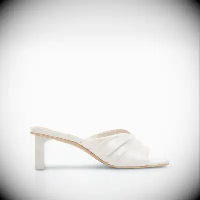 White satin low-heeled wedding shoes by Dolce Vita