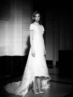 Boat neckline and short sleeves with lace flowers on bottom of skirt