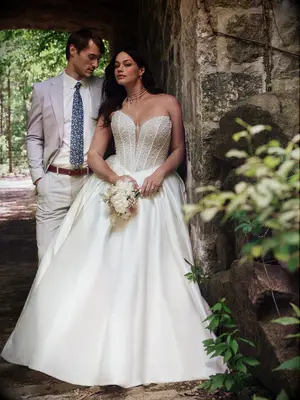 Bride and groom pose outdoors