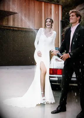 Bride and groom pose outdoors