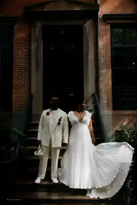 Bride and groom pose on steps