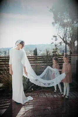 Bride wearing modest wedding dress with sweep train.