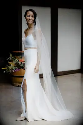 Bride wearing two piece wedding dress with court length train.