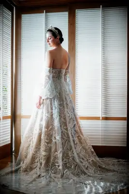 Bride wearing fairytale wedding dress with semi-cathedral train length.