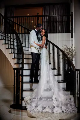 Groom with bride wearing cathedral length wedding dress