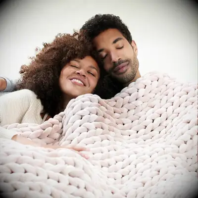 Couple snuggling under rose colored velvet weighted blanket anniversary gift for girlfriend