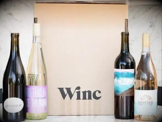 Winc box flanked by four lovely bottles of wine.