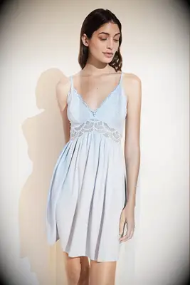 Woman wearing a light blue and lace night dress