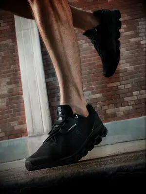 Close-up of black On running shoes on man running