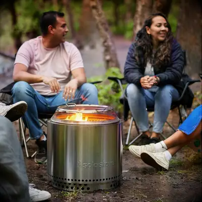 Friends sitting around Solo Stove fire pit