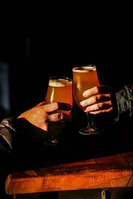 People doing a cheers with beer
