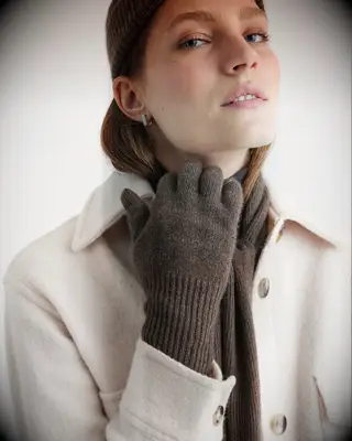Woman wearing cozy scarf and gloves