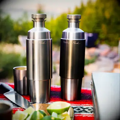 Flasks with integrated tumblers