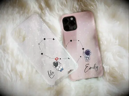 Matching pink and clear couples phone cases with connecting astrology heart 