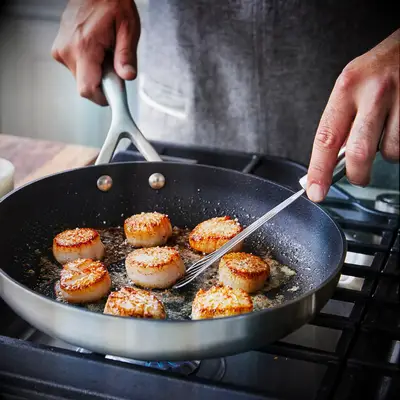 Man cooking scallops