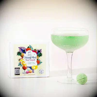 Cocktail bombs gift box pictured beside green drink