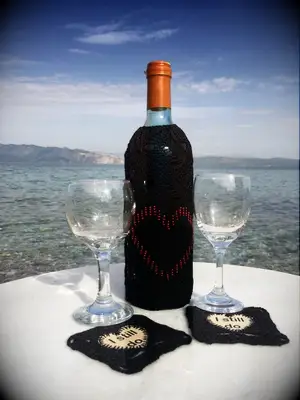 Black lace bottle bag with red heart design from Etsy