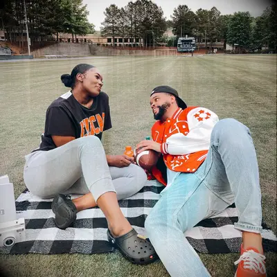 Couple enjoying a picnic on a football field