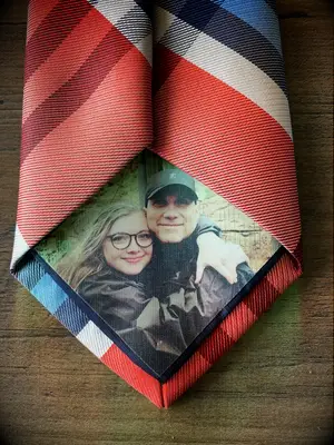 Tie patch features a printed photograph of a smiling couple. 