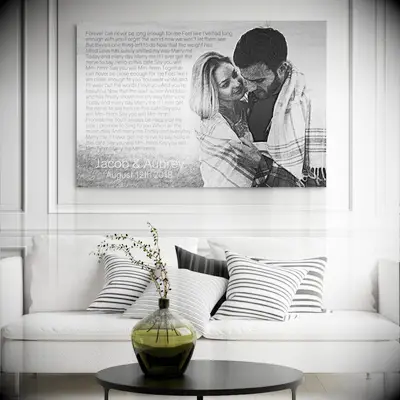 A living room displays a large canvas drawing of an embracing couple. 
