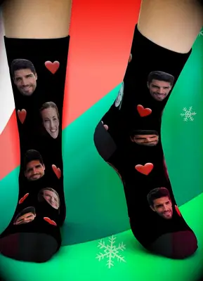 Model wears socks that feature faces on them. 