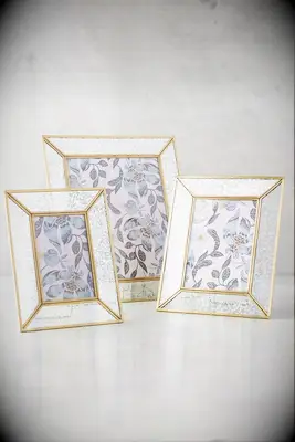 Three chic photo frames with gold detailing. 