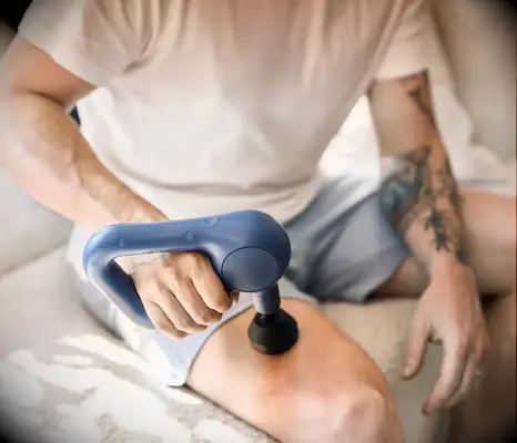 Theragun handheld massage on thigh