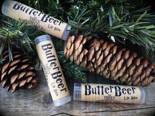 Lip balm with brown wrap that says Butterbeer in HP font and the Three Broomsticks logo