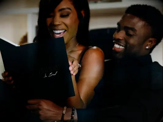 Couple smiling and reading The Adventure Challenge for Valentine