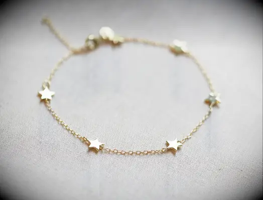 A yellow gold chain bracelet with five stars gift for daughter in law