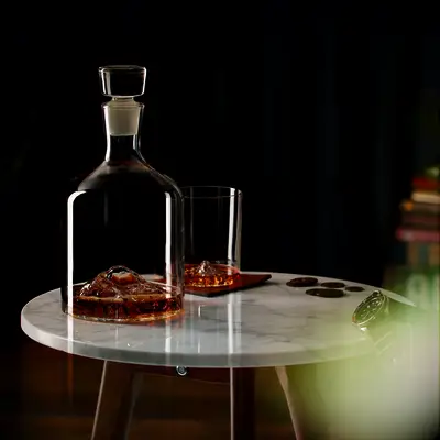 Whiskey decanter and glass featuring glass mountains. 