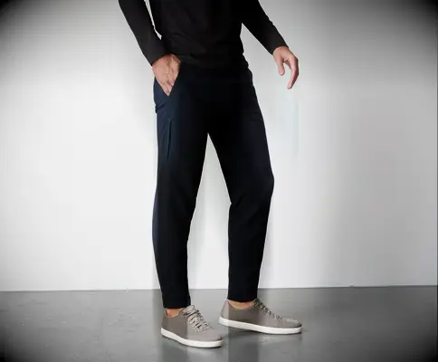 Model wears comfortable navy blue sweatpants. 