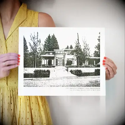Woman holds a custom print of a beautiful house housewarming gift for couple