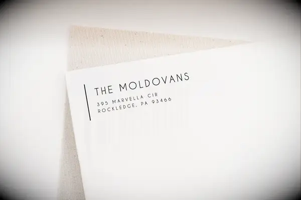 Custom return label stamp on a cream-colored envelope housewarming gift for couples