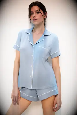 Woman wearing short blue pajamas