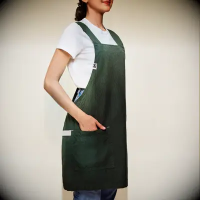 Woman wearing a green linen apron anniversary gift